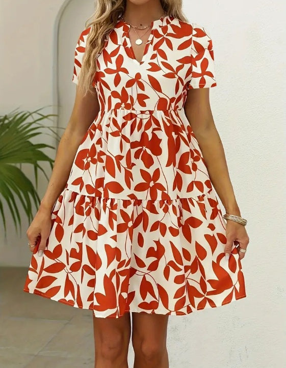 Women's fashionable short sleeve summer dress with red floral pattern.
